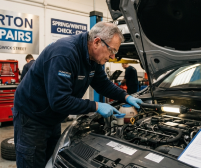 Professional mechanic performing a seasonal car maintenance check on a vehicle in a Homerton, Hackney garage.